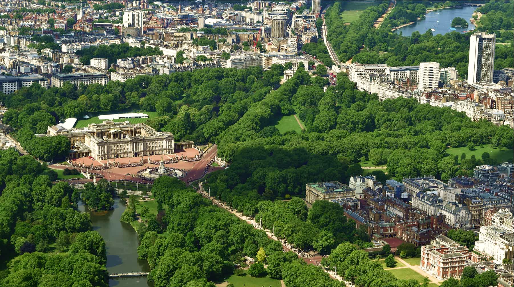 Aerial view of Buckingham Palace surrounded by greenery.