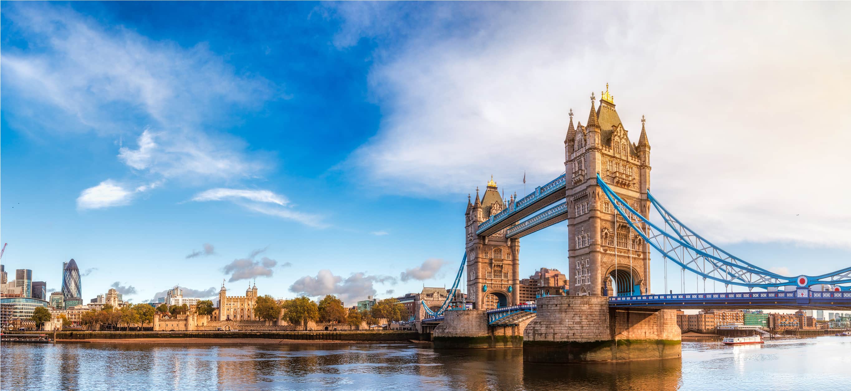 Tower Bridge over River Thames on sunny day.