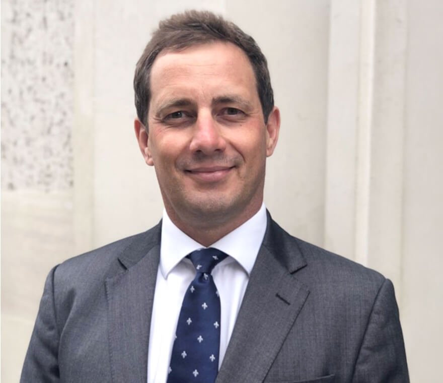 Man in suit smiling outdoors