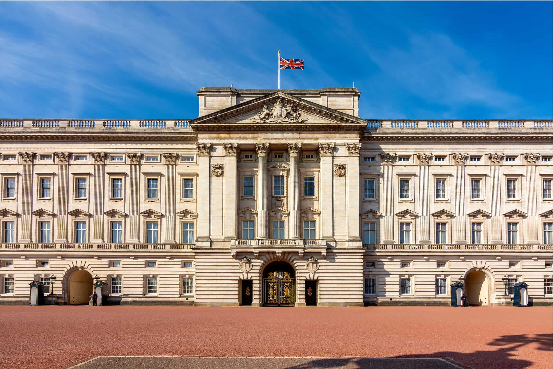 Buckingham Palace facade and Union Jack flag flying.