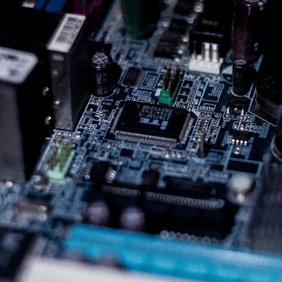 Close-up of a computer motherboard with circuit elements.