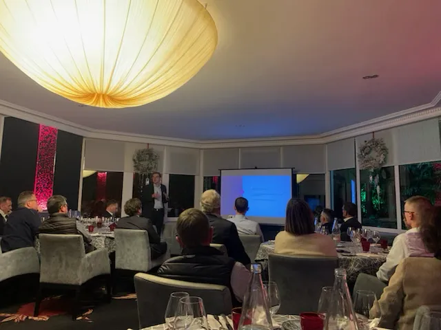 Business presentation in a dimly lit conference room.