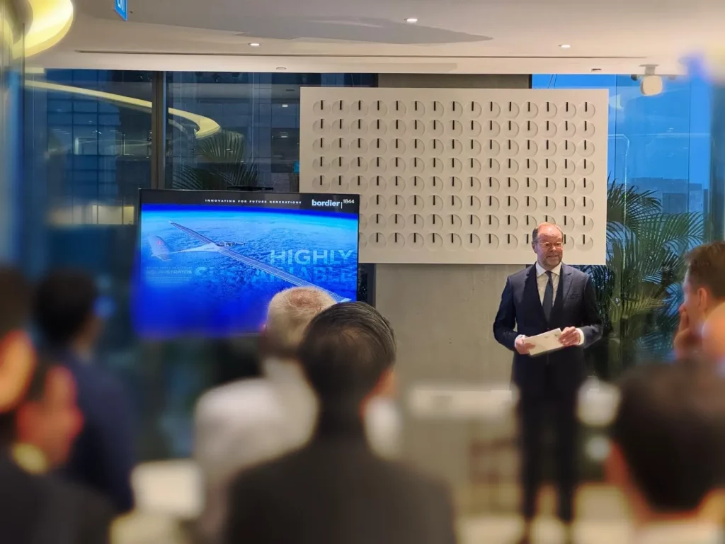 Man presenting to audience at business event.