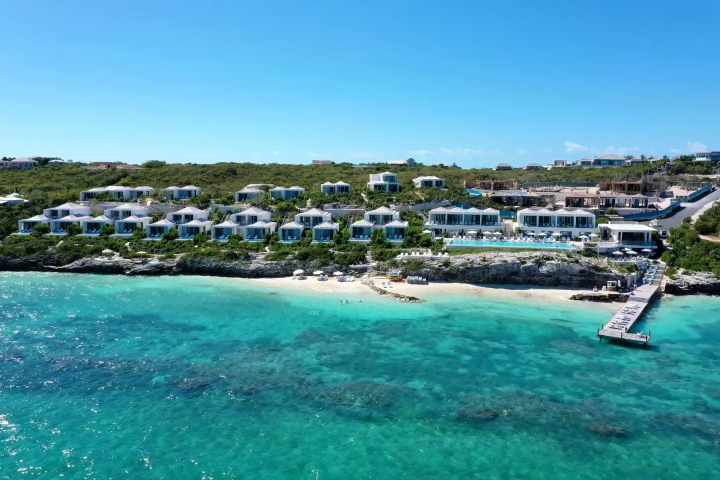 Luxury beachfront resort with turquoise water views.